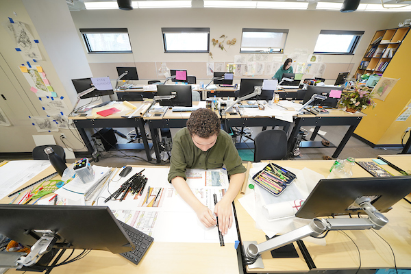 student at desk in a classroom
